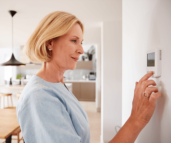 Woman adjusting thermometer